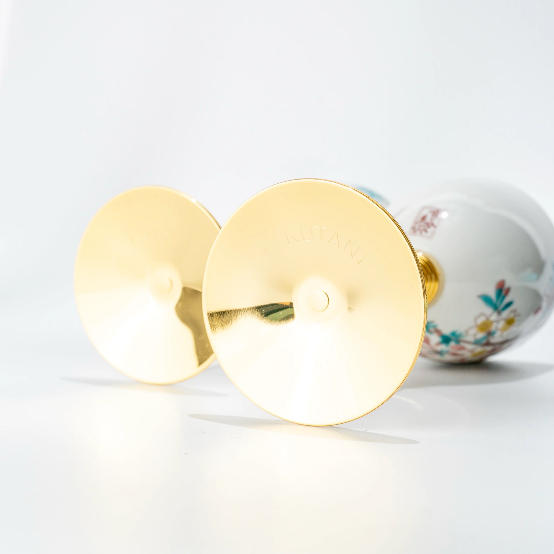 Bottom view of two Kutani wine cups showing gold bases and stems