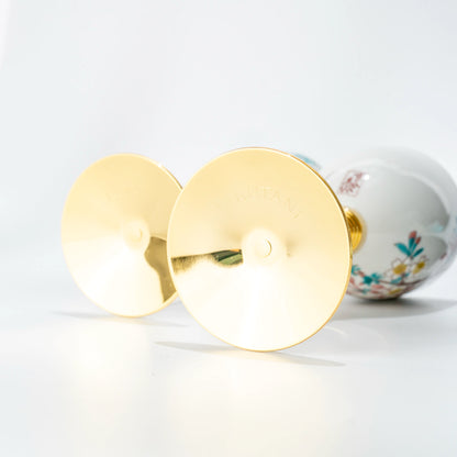 Bottom view of two Kutani wine cups showing gold bases and stems