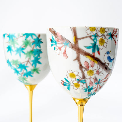 Front close-up of a Kutani wine cup pair with contrasting bird and seasonal motifs