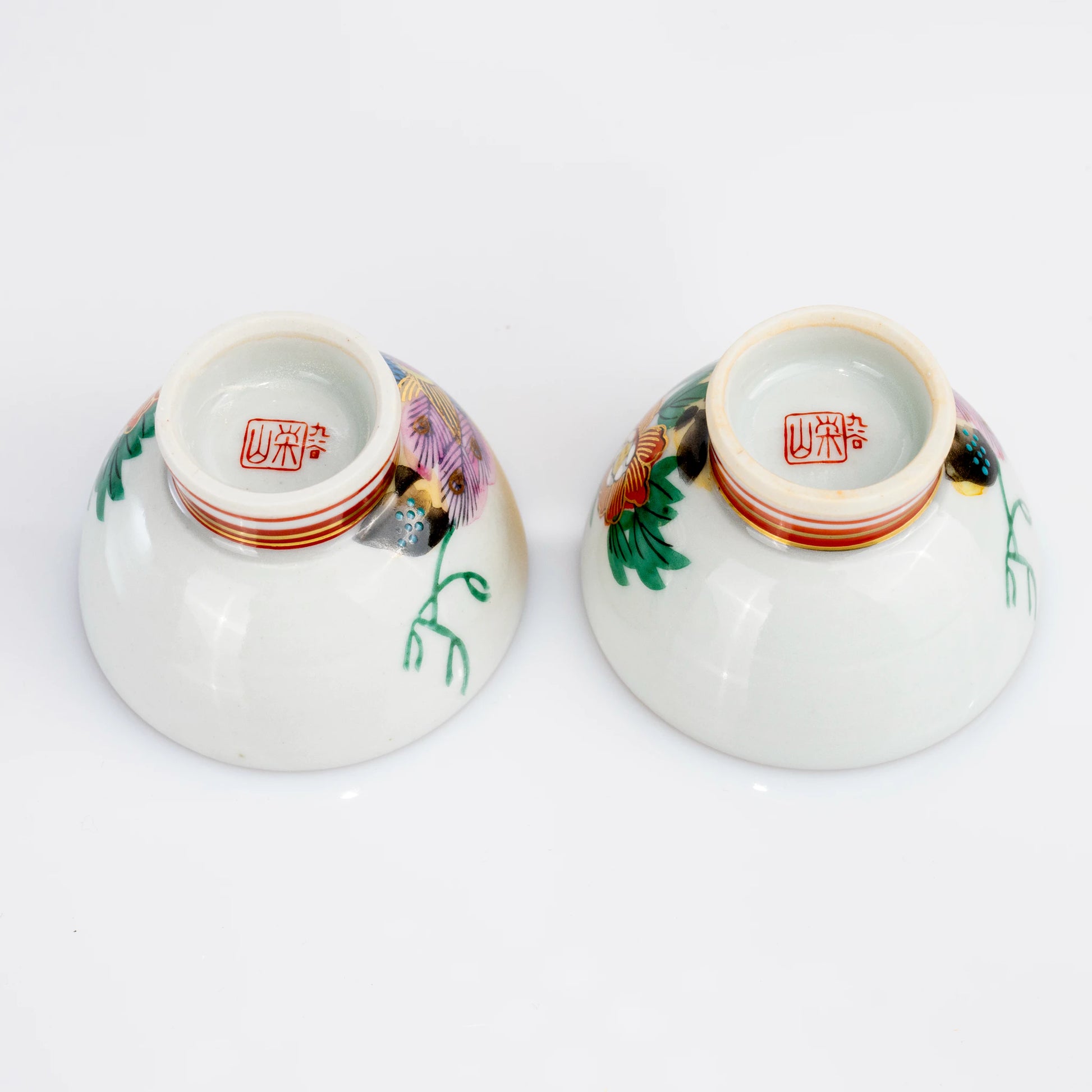 Bottom view of two Kutani ochoko cups showing maker marks