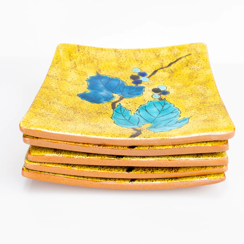 Stack of five Kutani Yoshidaya wild grape square plates front view