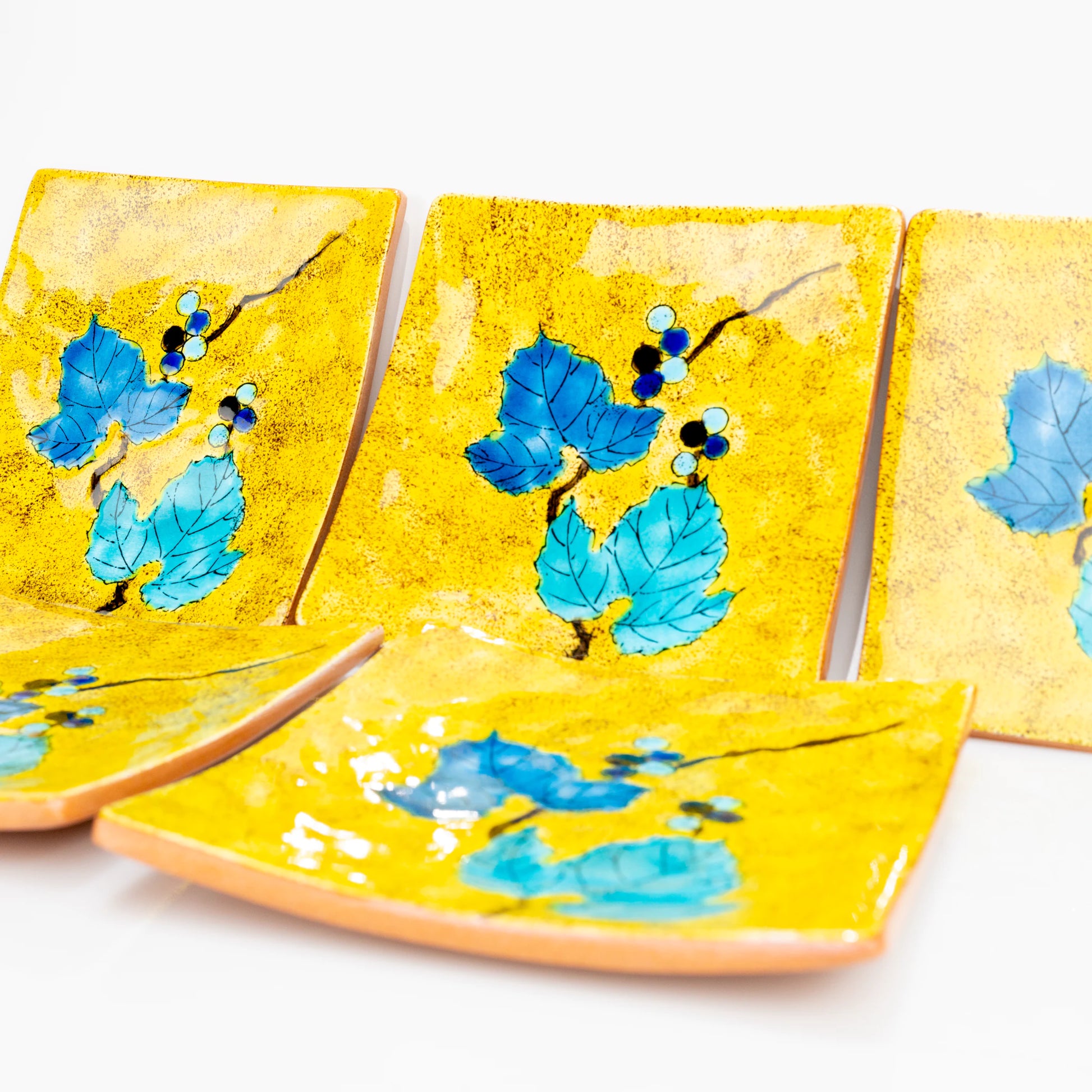 Close view of Kutani Yoshidaya wild grape square plates layered together