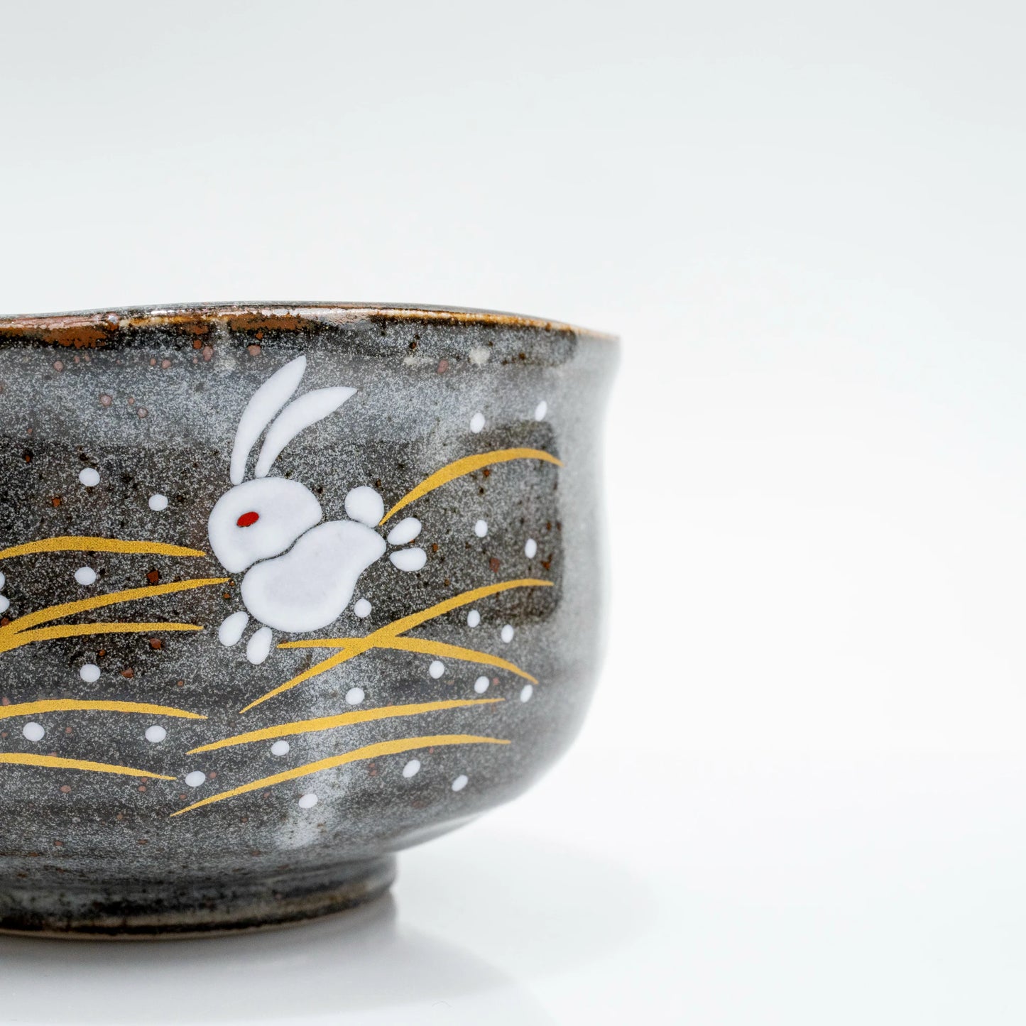 Close-up side detail of Kutani hare rabbit matcha bowl with painted rabbit design