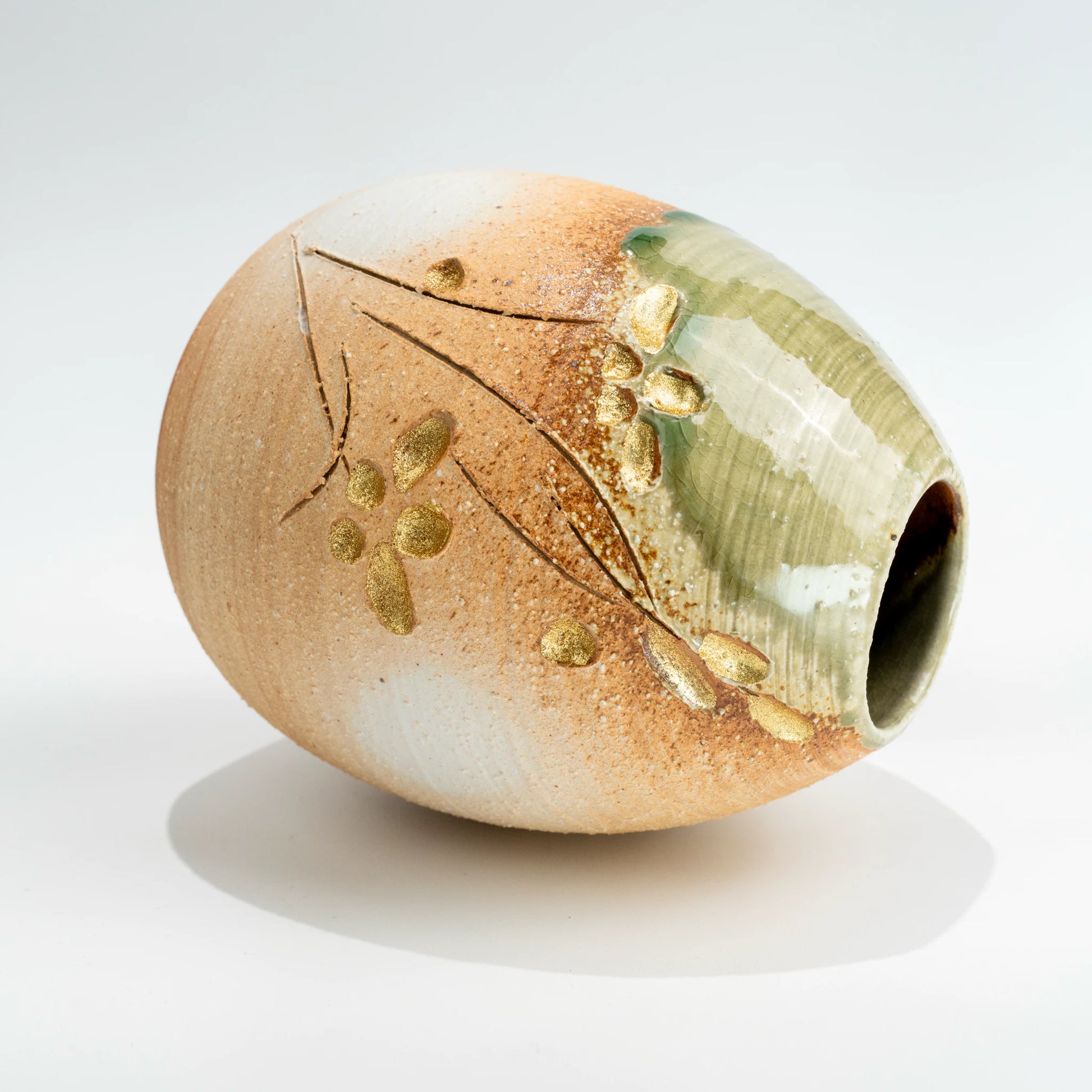 Side view of handmade Shigaraki ceramic vase laid horizontally