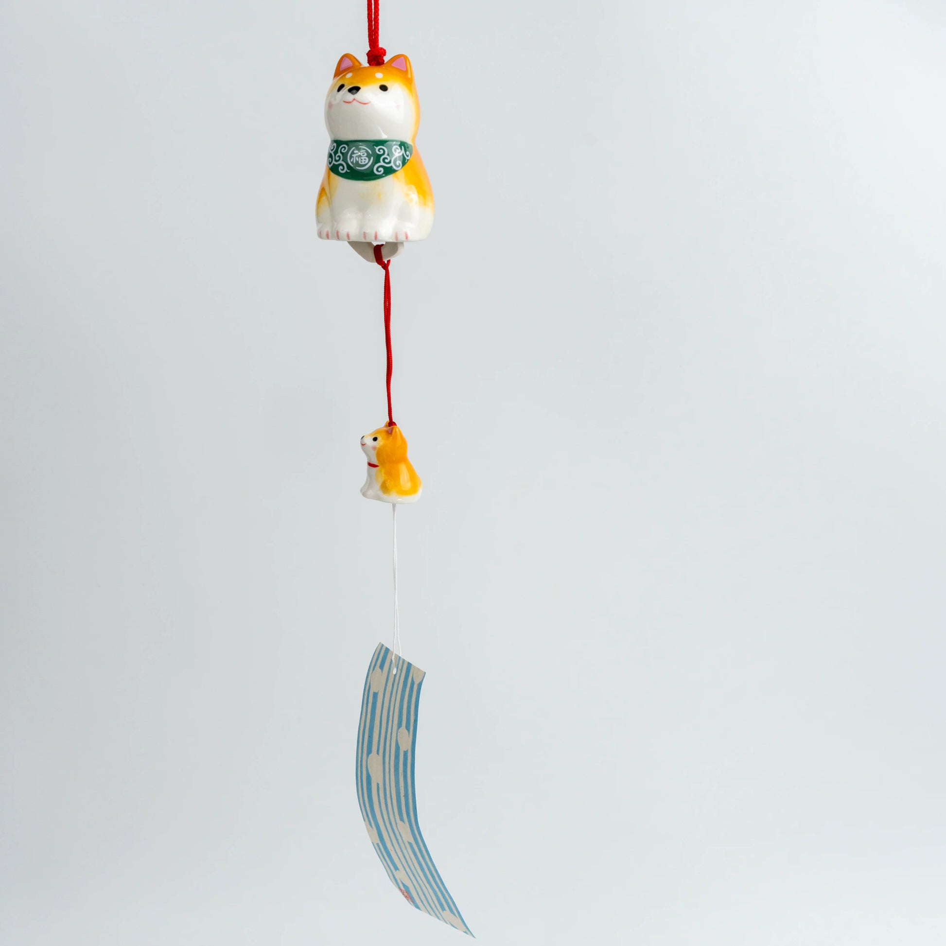 Full hanging view of Shiba Inu wind chime with paper strip