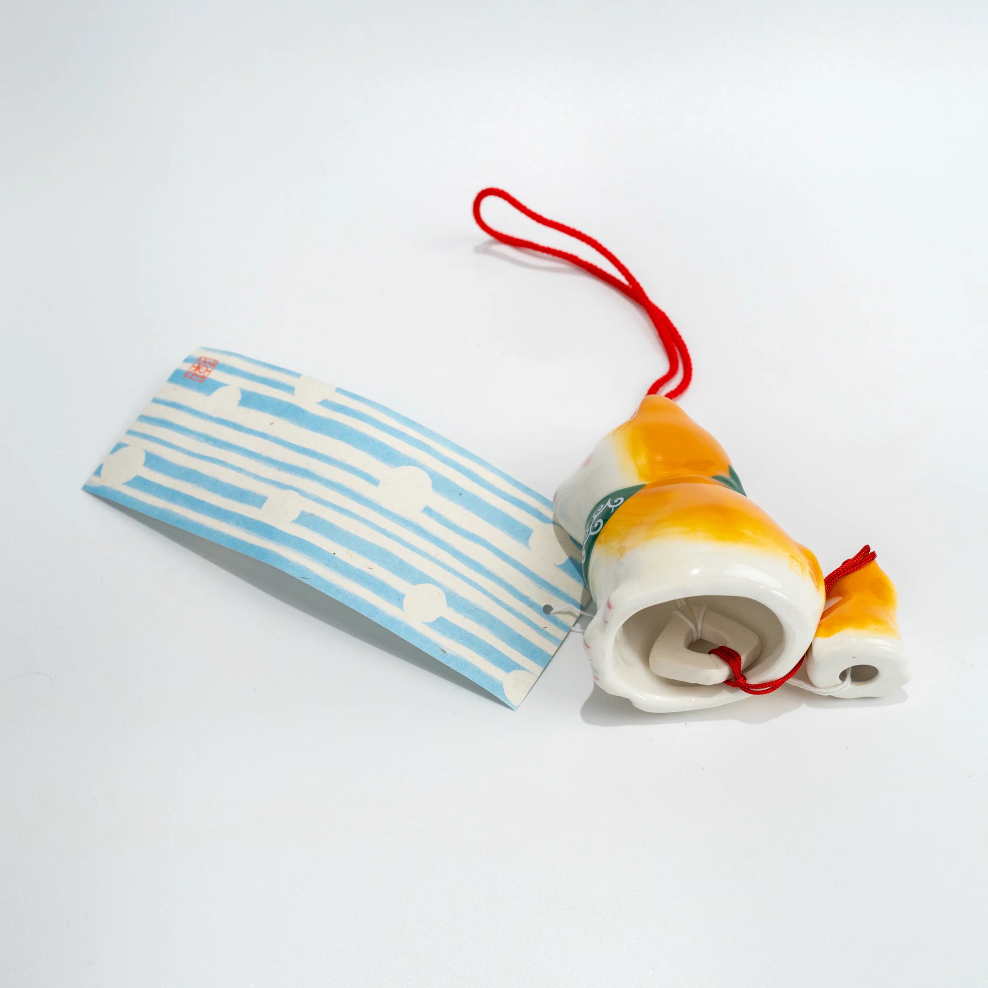 Side and underside angle of Shiba Inu wind chime with hanging strip