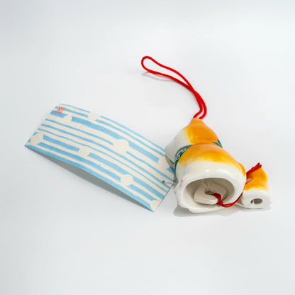 Side and underside angle of Shiba Inu wind chime with hanging strip