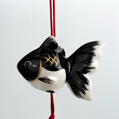 Angled close-up of black goldfish ceramic furin bell