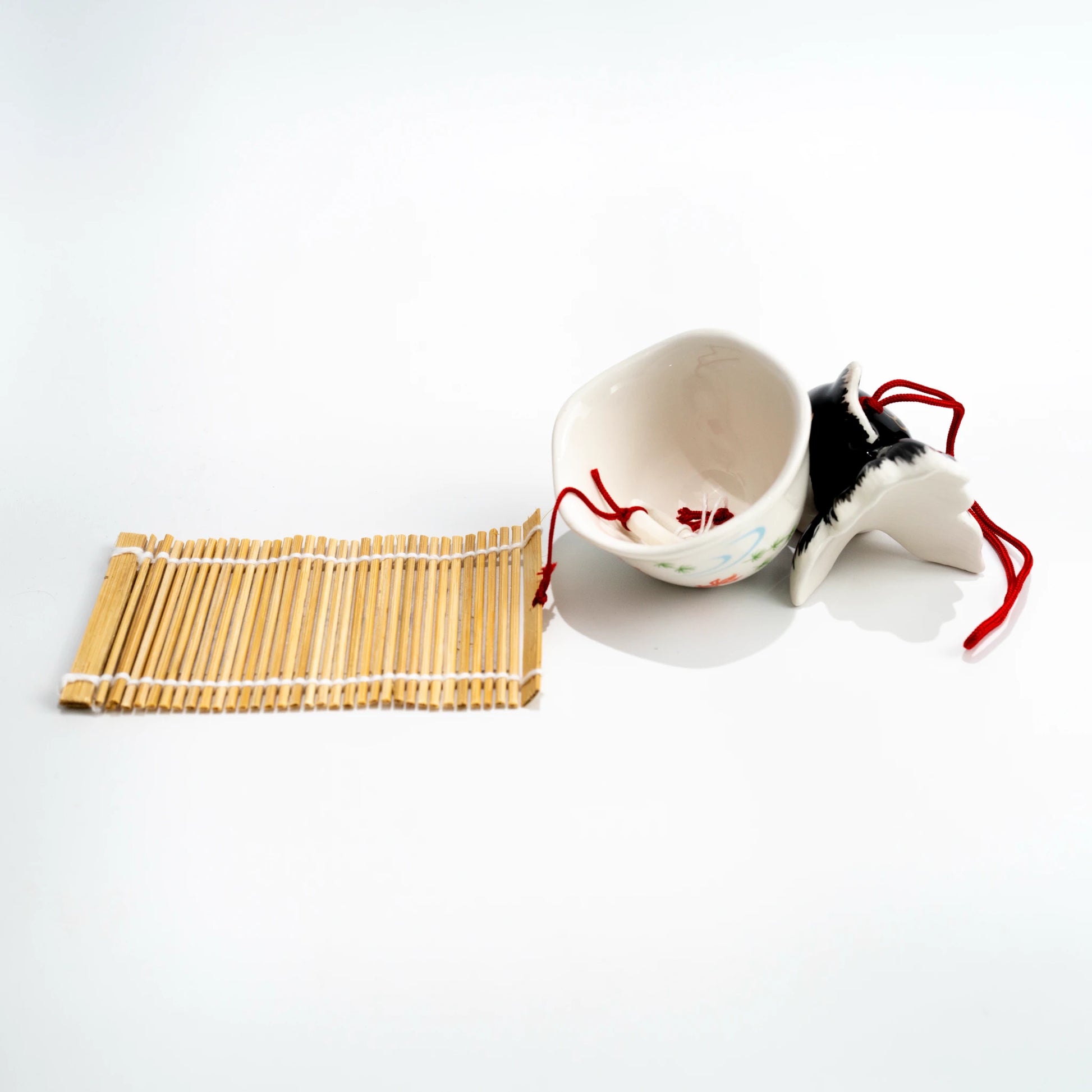 Side and underside view of black goldfish wind chime