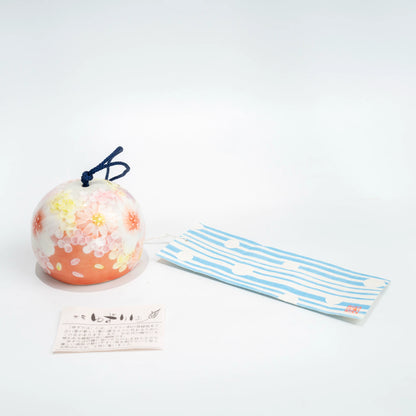 Full hanging view of pink floral ceramic furin with blue strip