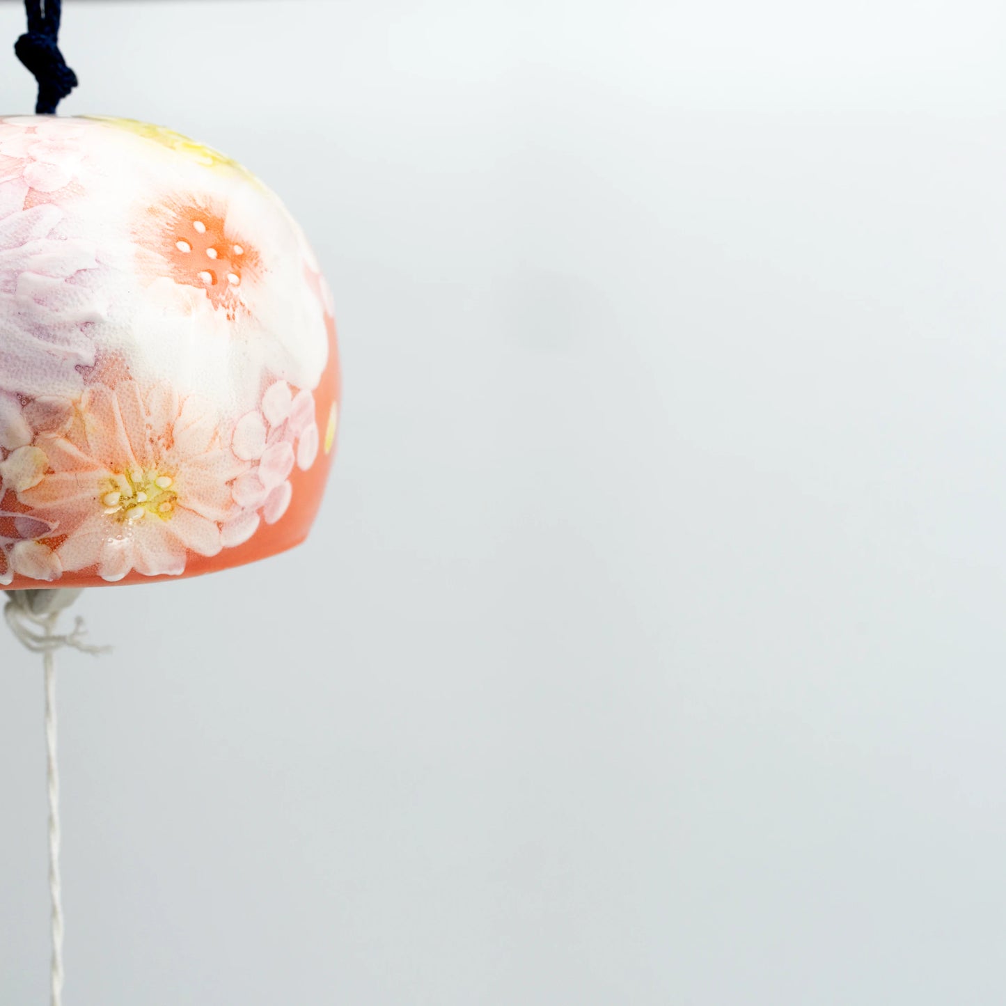 Flat lay of Yuzuriha floral wind chime with blue paper strip and tag