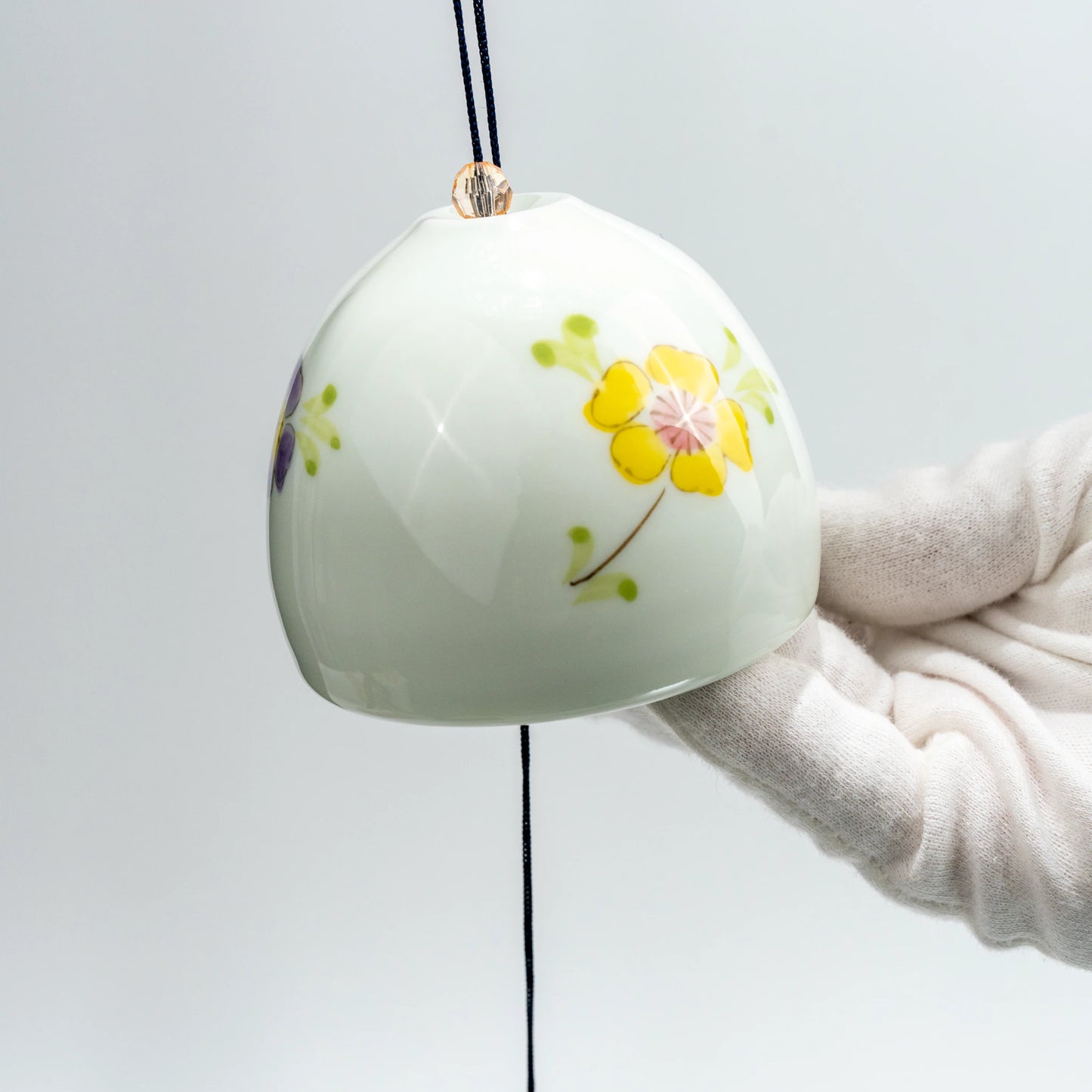 Close-up angled view of Japanese porcelain floral wind chime
