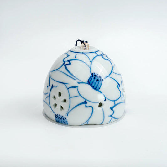 Front of the white Arita wind-chime bell with a large blue sazanka flower