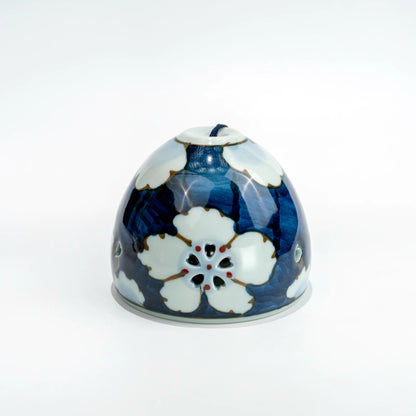 Front view of Arita floral openwork porcelain wind chime bell