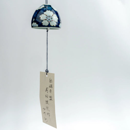 Full hanging view of Arita floral openwork wind chime with decorative paper strip