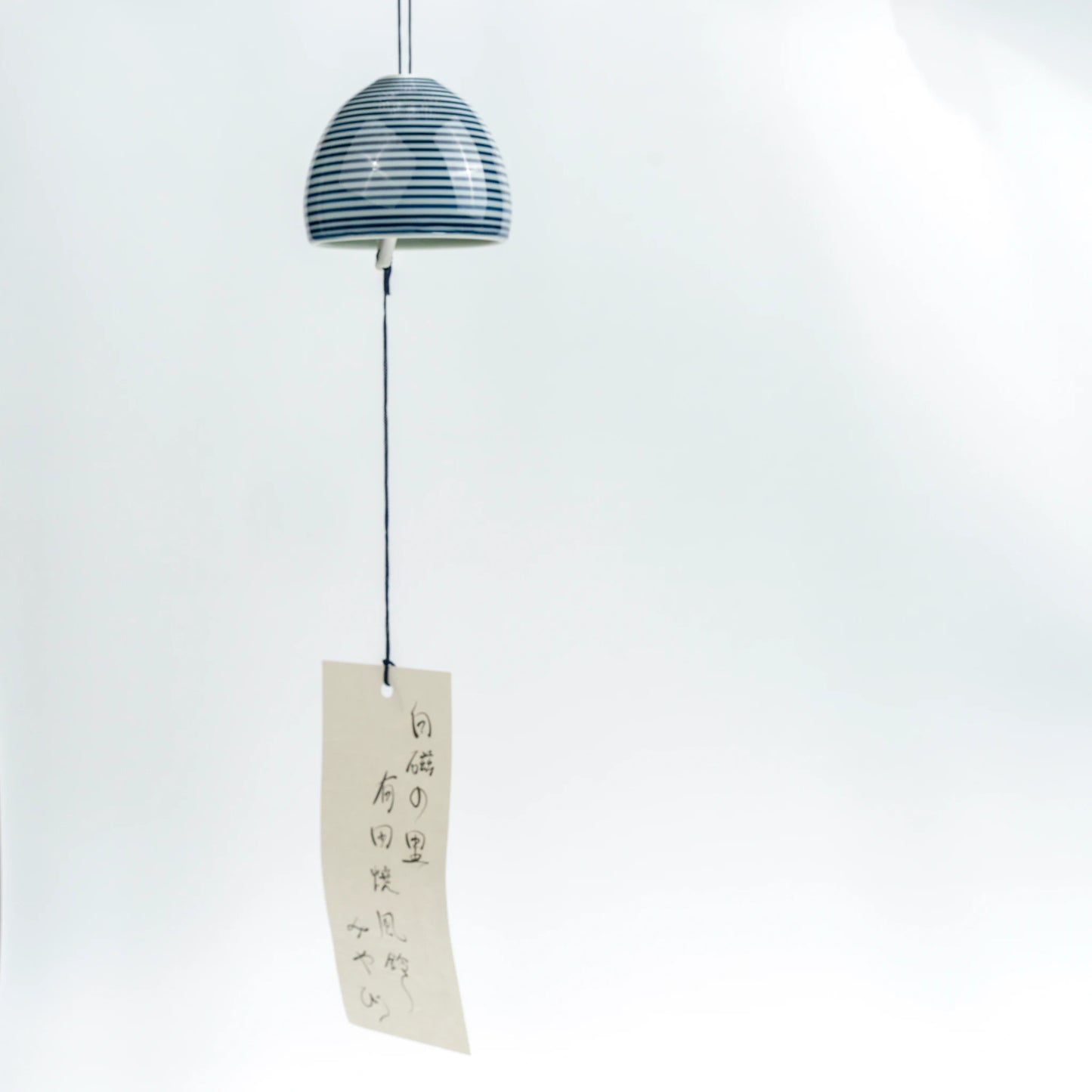 Full hanging view of Arita stripe wind chime with paper strip