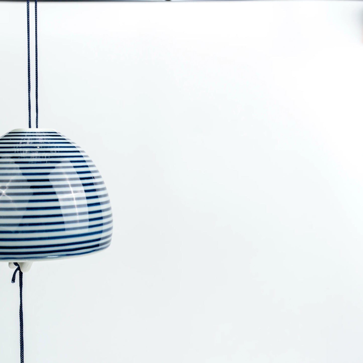 Close side hanging view of Japanese ceramic stripe wind chime
