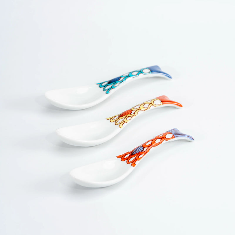 Three Kutani porcelain whale renge spoons stacked to show the curved bowls and patterned tail handles