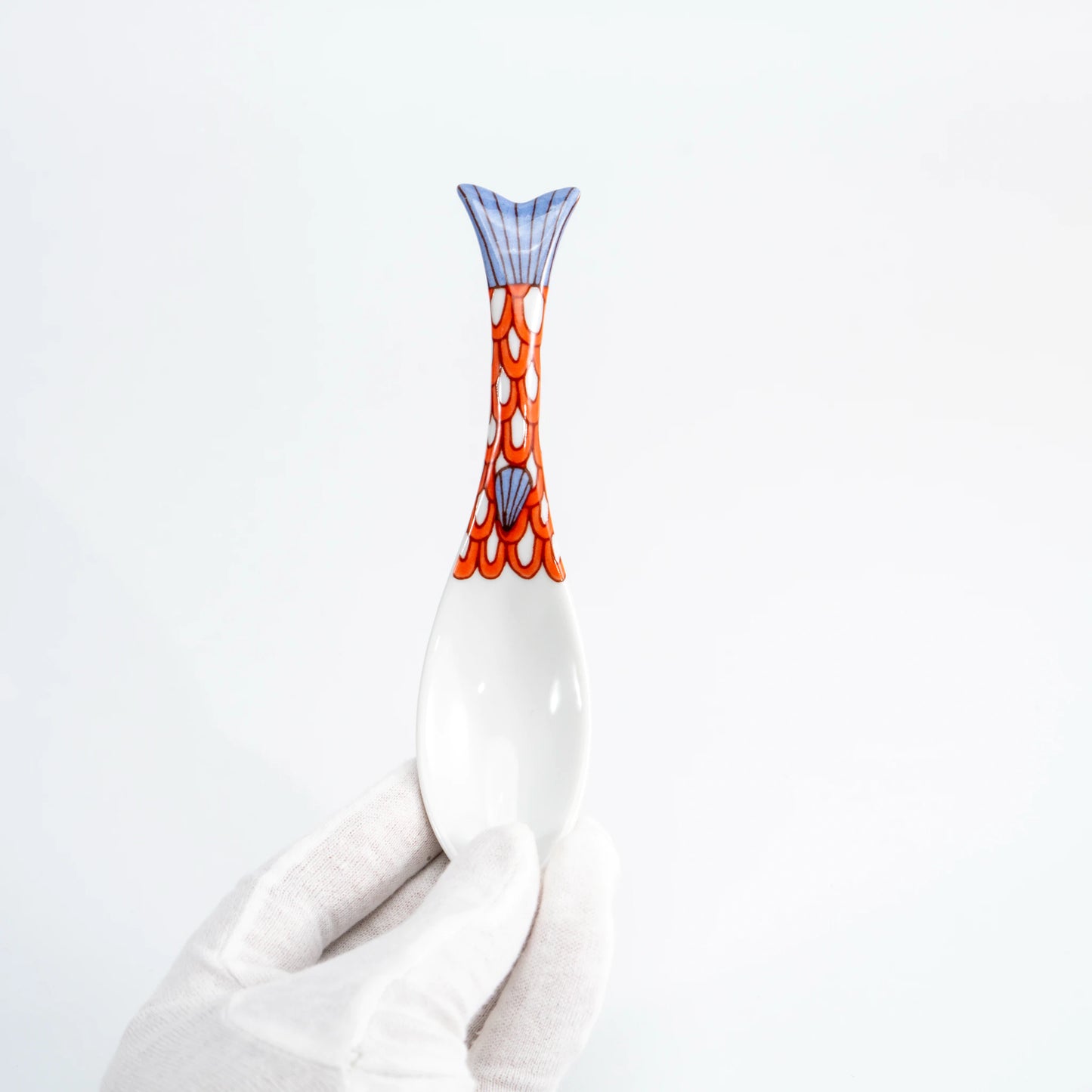 Hand-held purple Kutani whale renge spoon showing the patterned whale-tail handle
