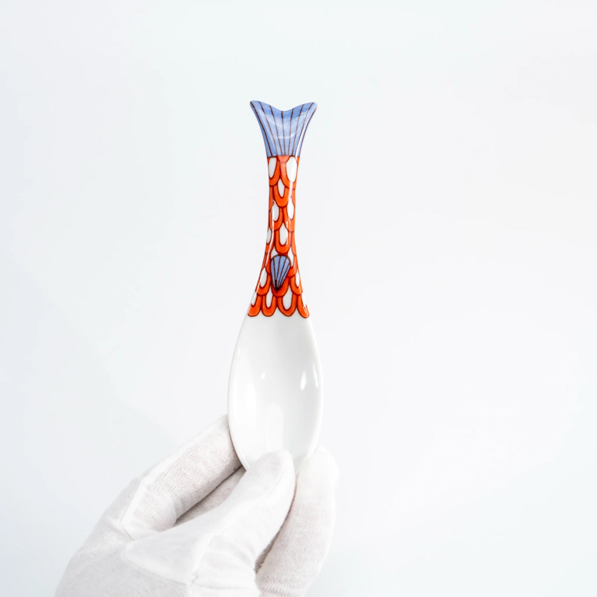 Hand-held purple Kutani whale renge spoon showing the patterned whale-tail handle