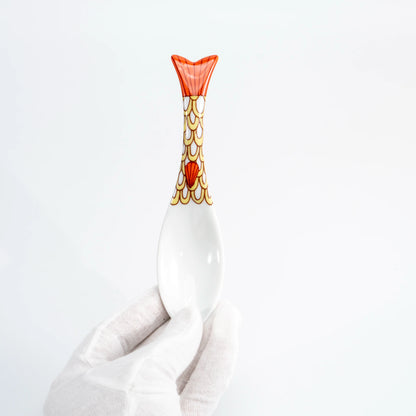 Hand-held yellow Kutani whale renge spoon showing the patterned whale-tail handle