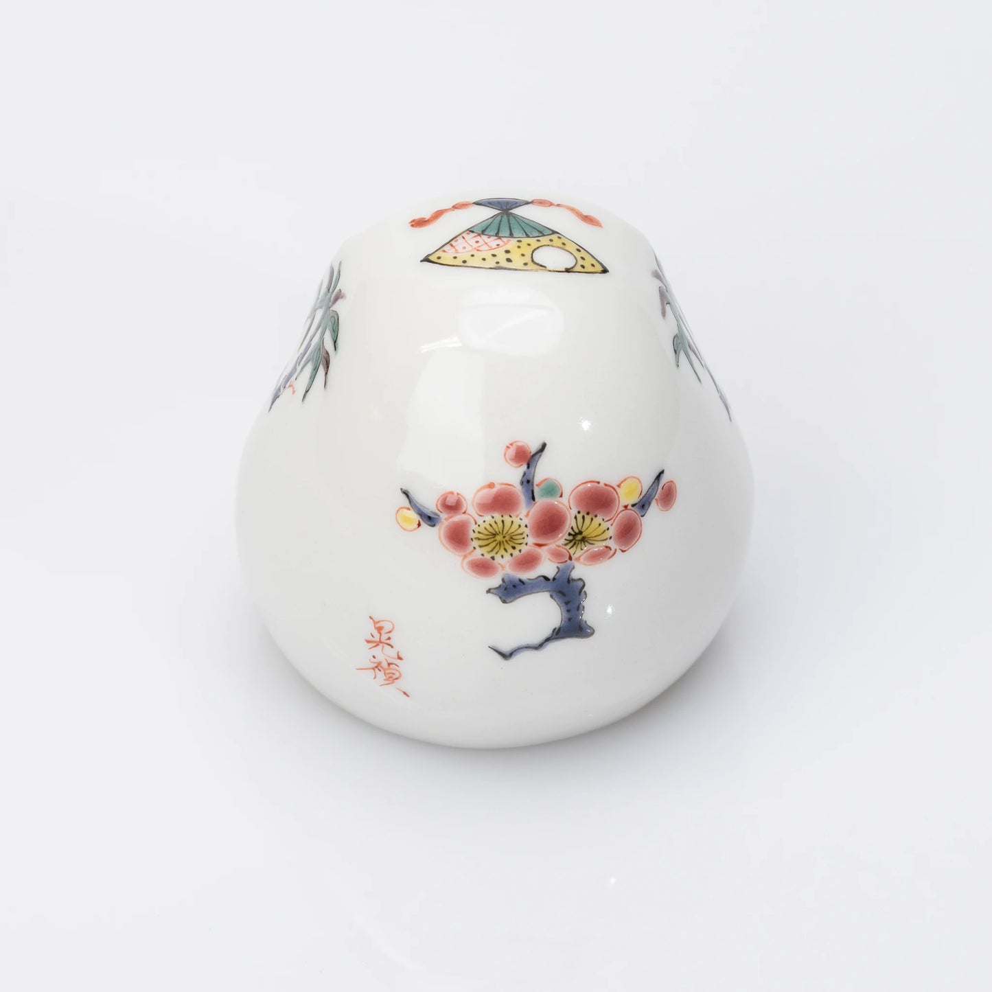 Back view of white Kutani Daruma with plum blossom motif