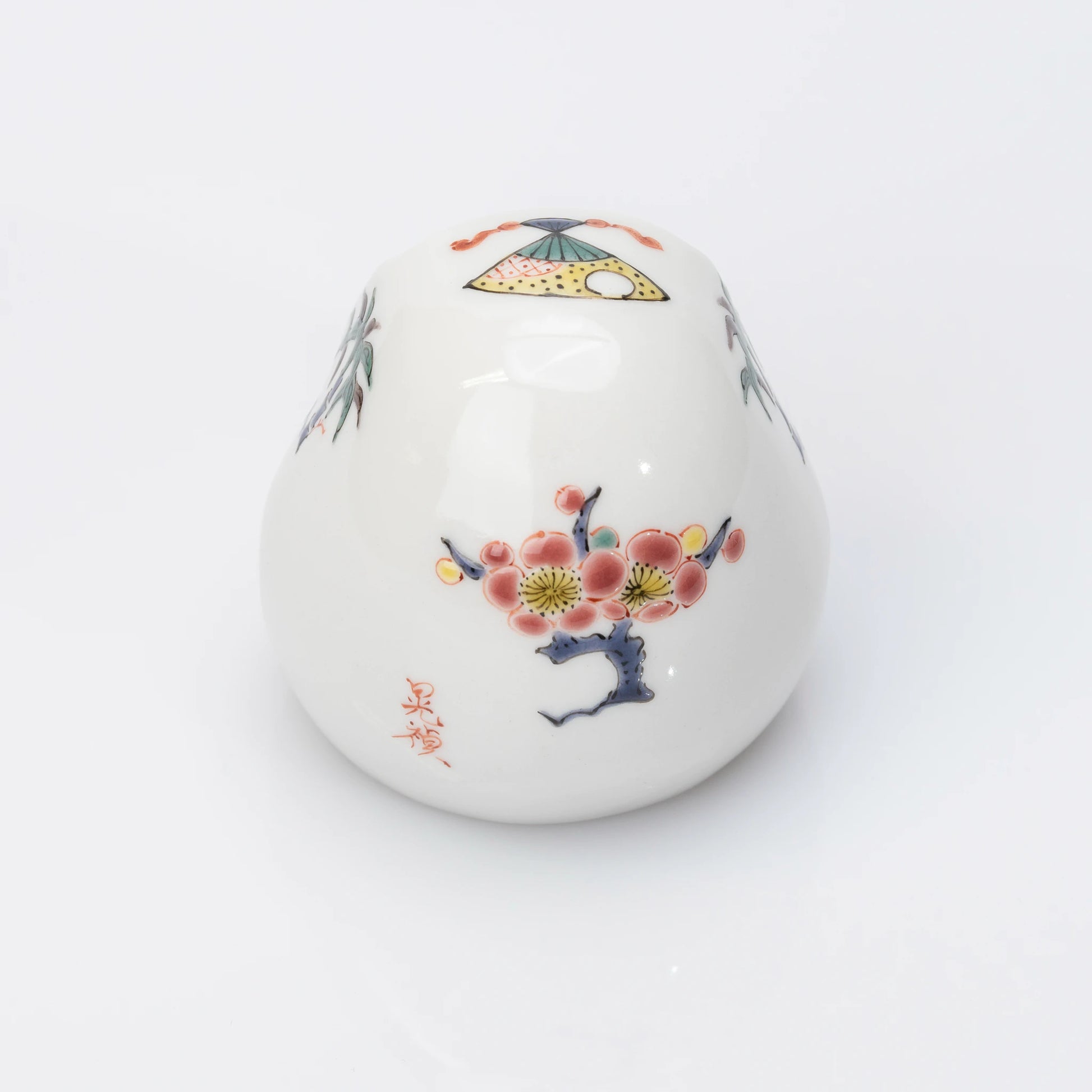 Back view of white Kutani Daruma with plum blossom motif
