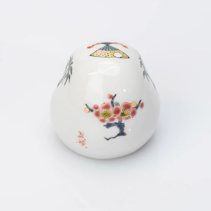 Back view of white Kutani Daruma with plum blossom motif