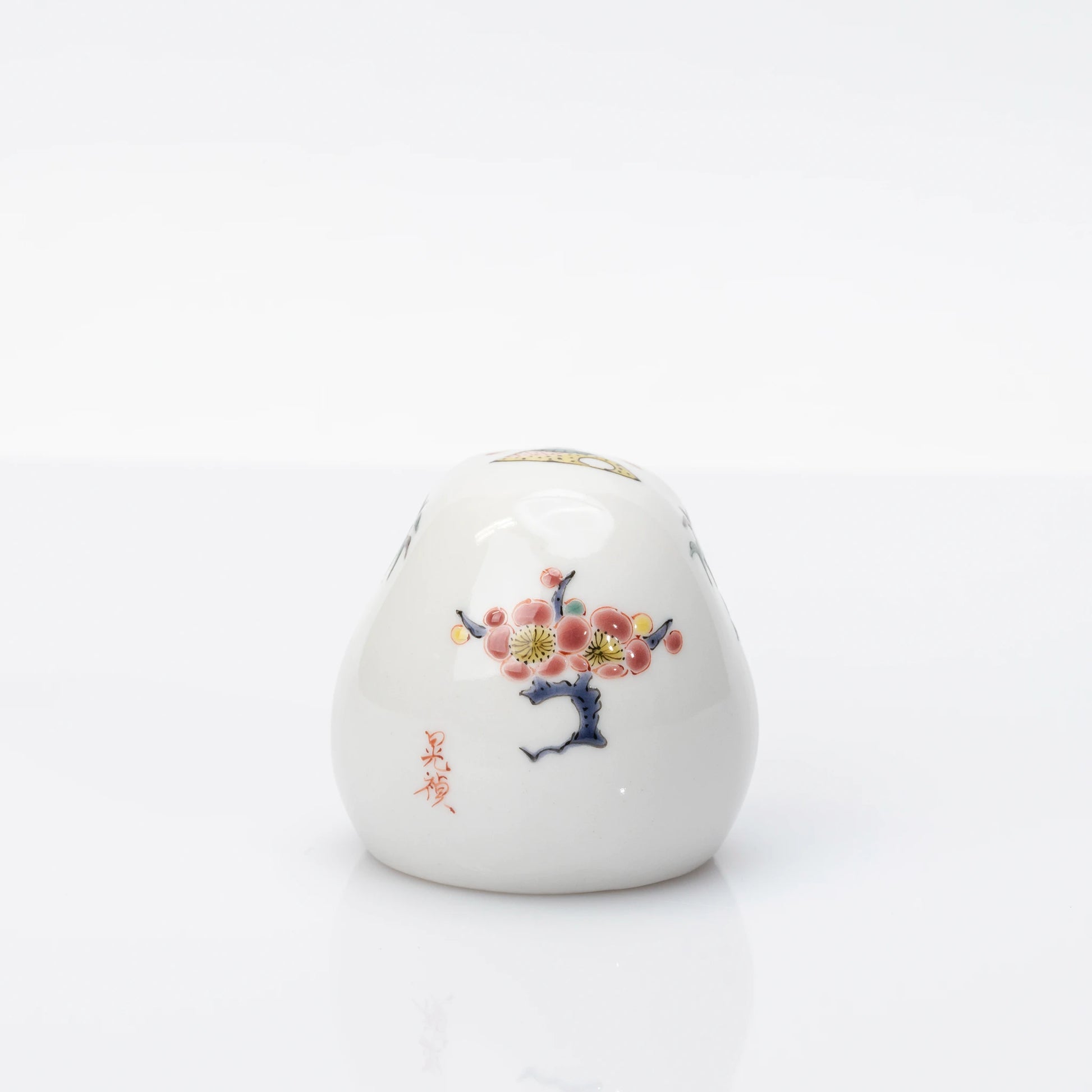Rear view showing plum blossom decoration on Kutani Daruma