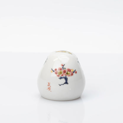 Rear view showing plum blossom decoration on Kutani Daruma