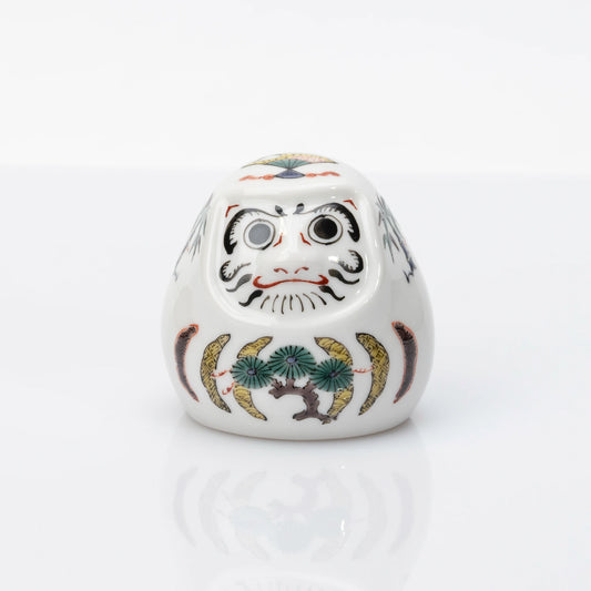 Front view of white Kutani Daruma with pine, bamboo and plum motifs