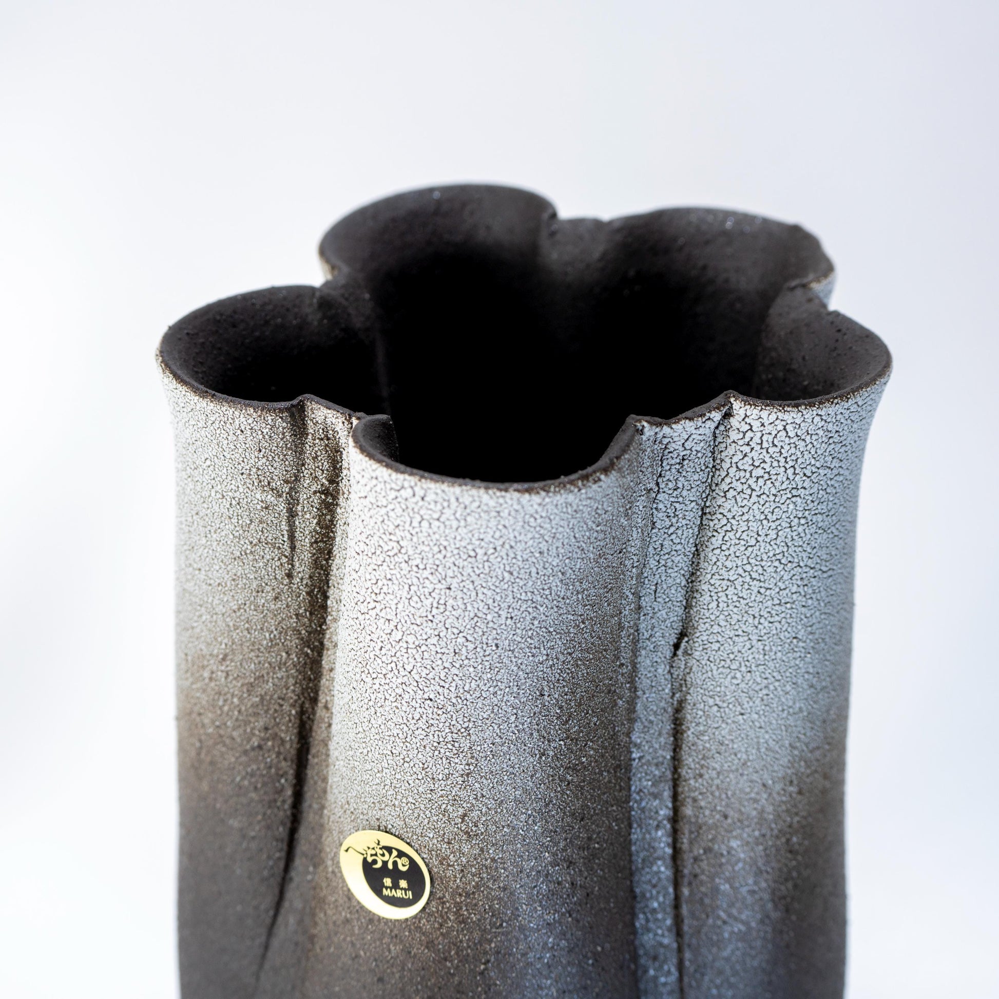 Texture detail of handmade Shigaraki tall vase in black and white glaze