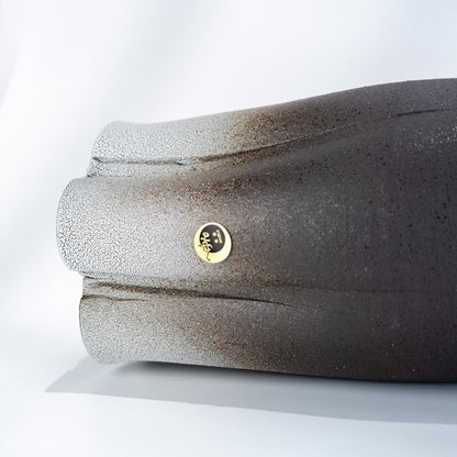 Close-up side detail of Shigaraki black stoneware vase with white glaze
