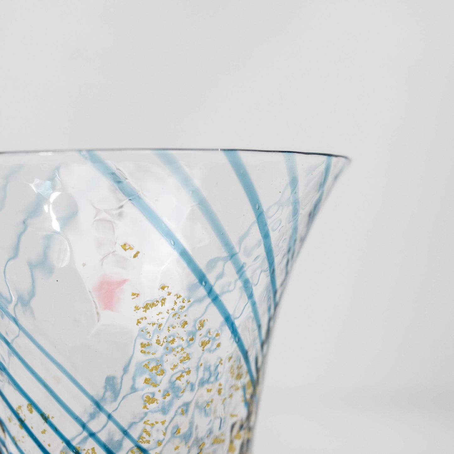 Close-up of gold pattern on blue sake cup