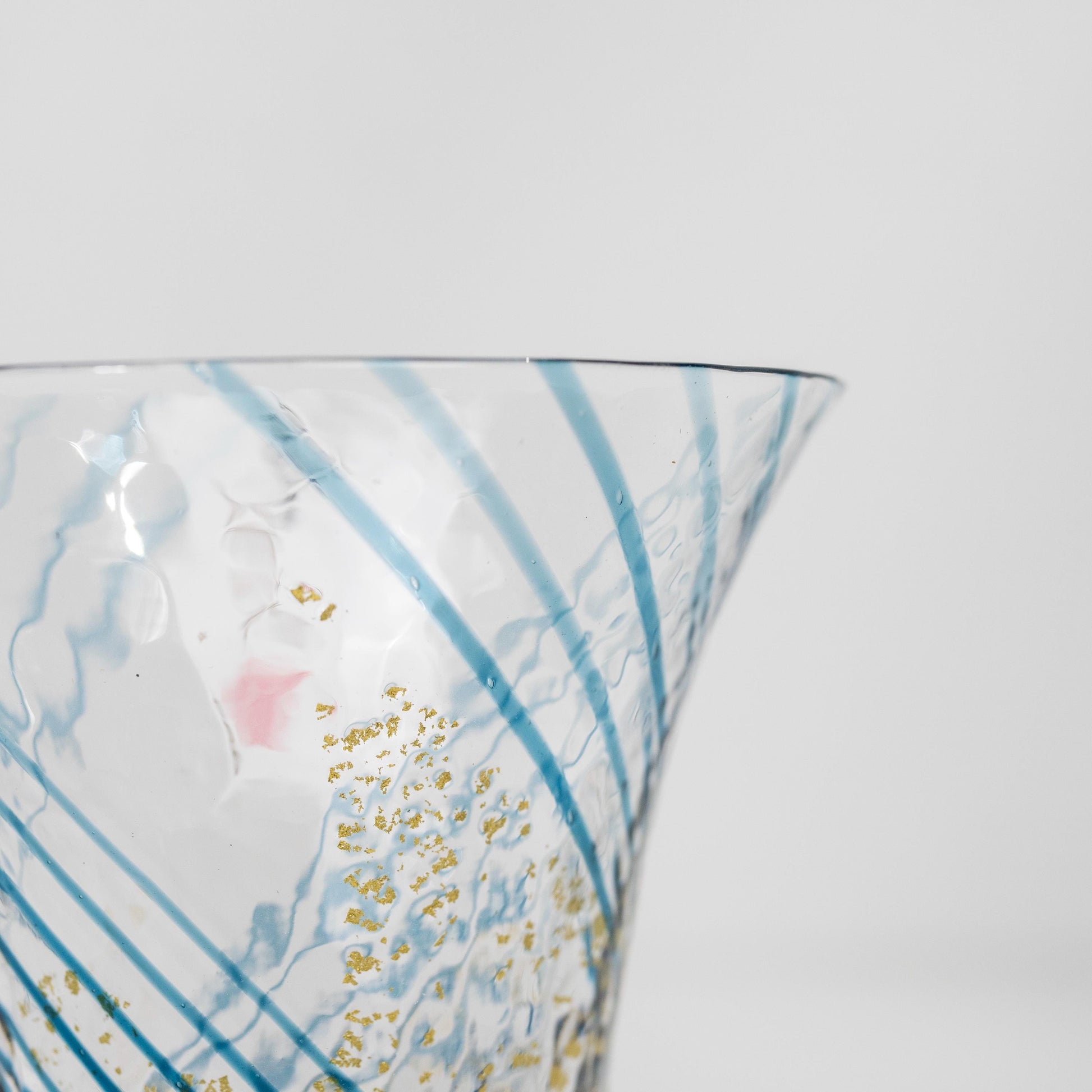 Close-up of gold pattern on blue sake cup