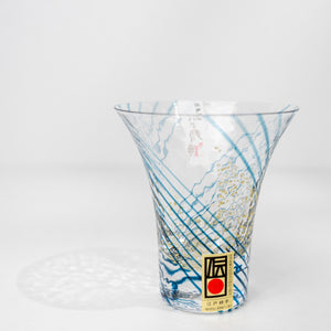 Angled view of blue crystal sake cup with gold pattern