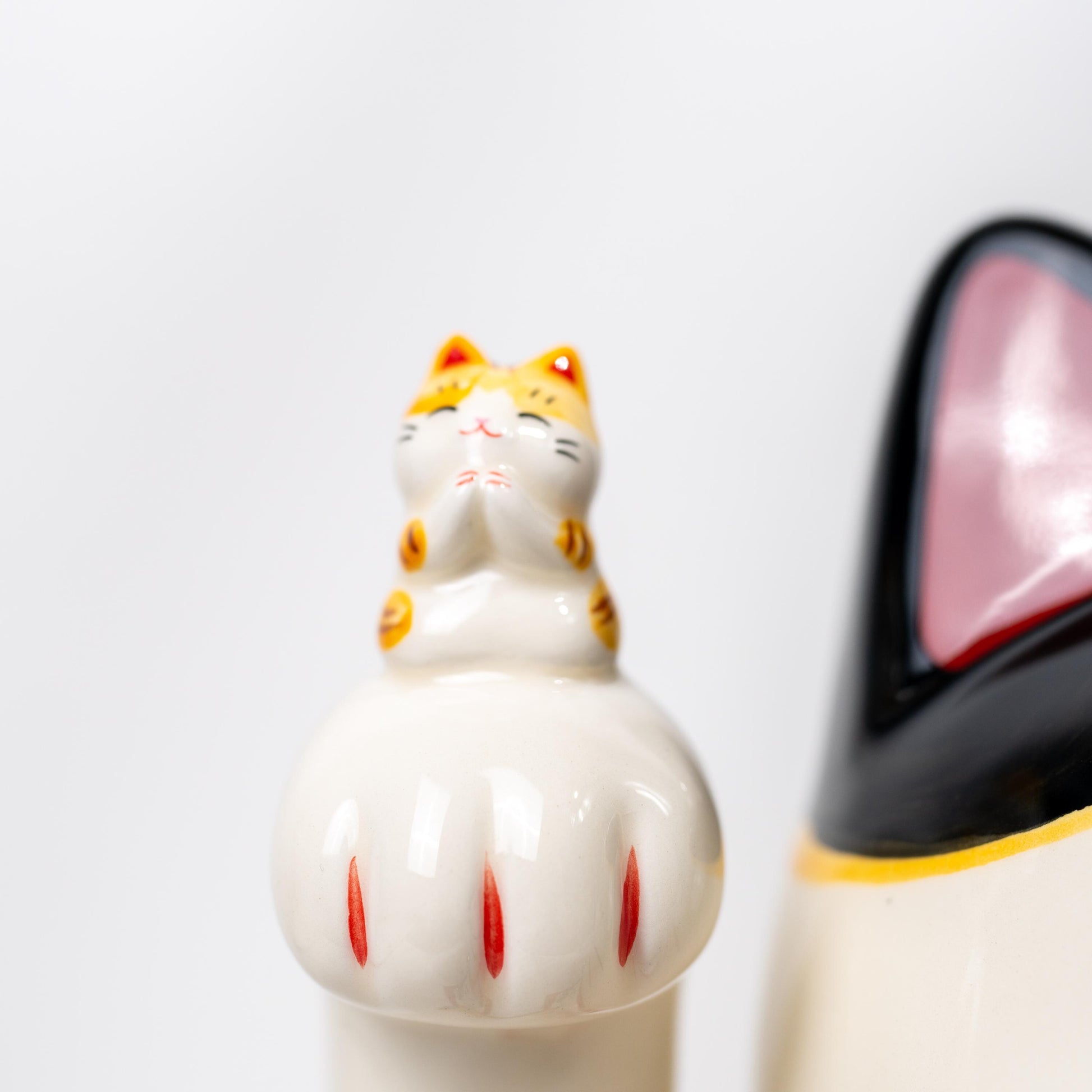 Back view of ceramic beckoning cat figurine