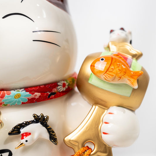 Front view of ceramic lucky cat figurine with raised paw