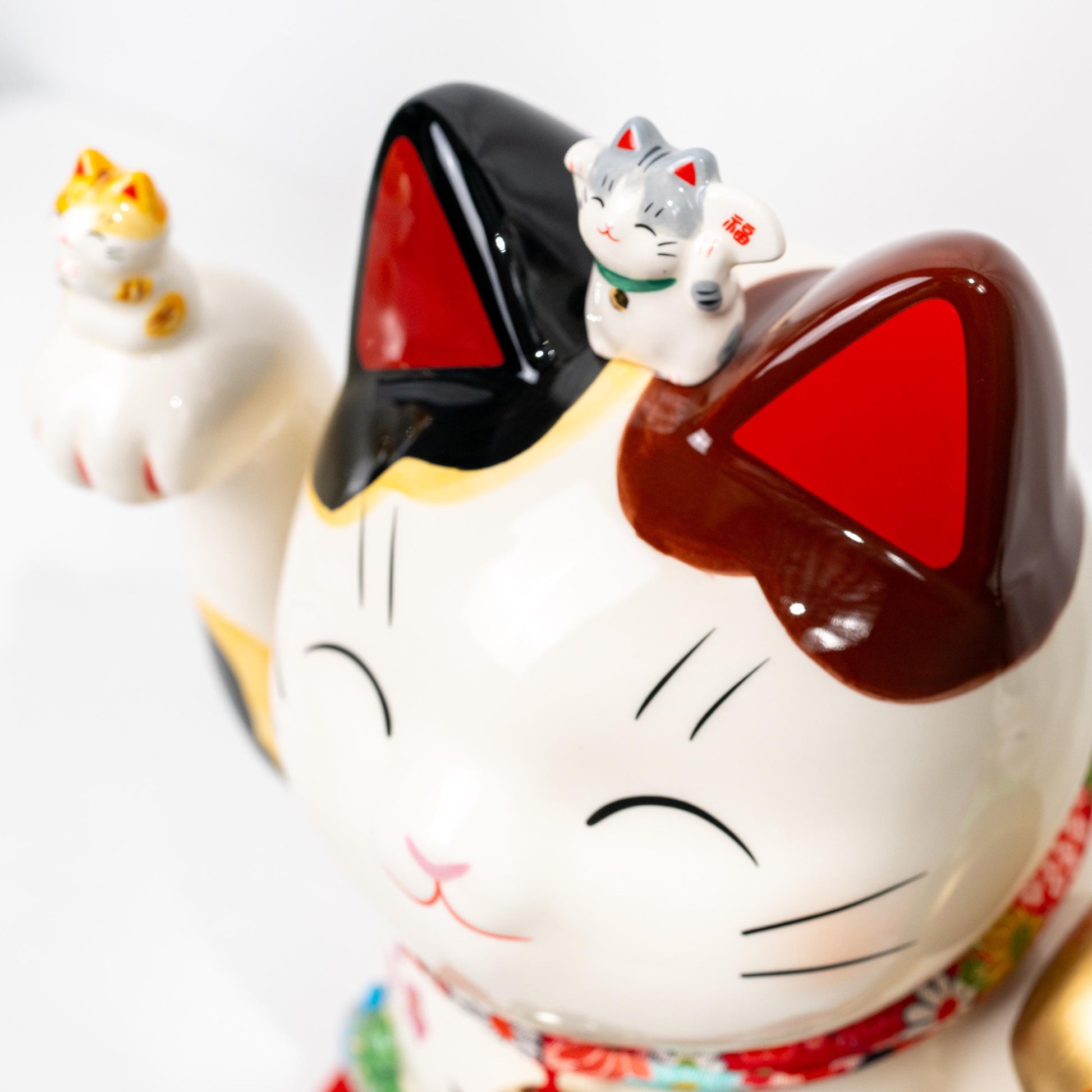 Close-up of face and upper body on large maneki neko statue