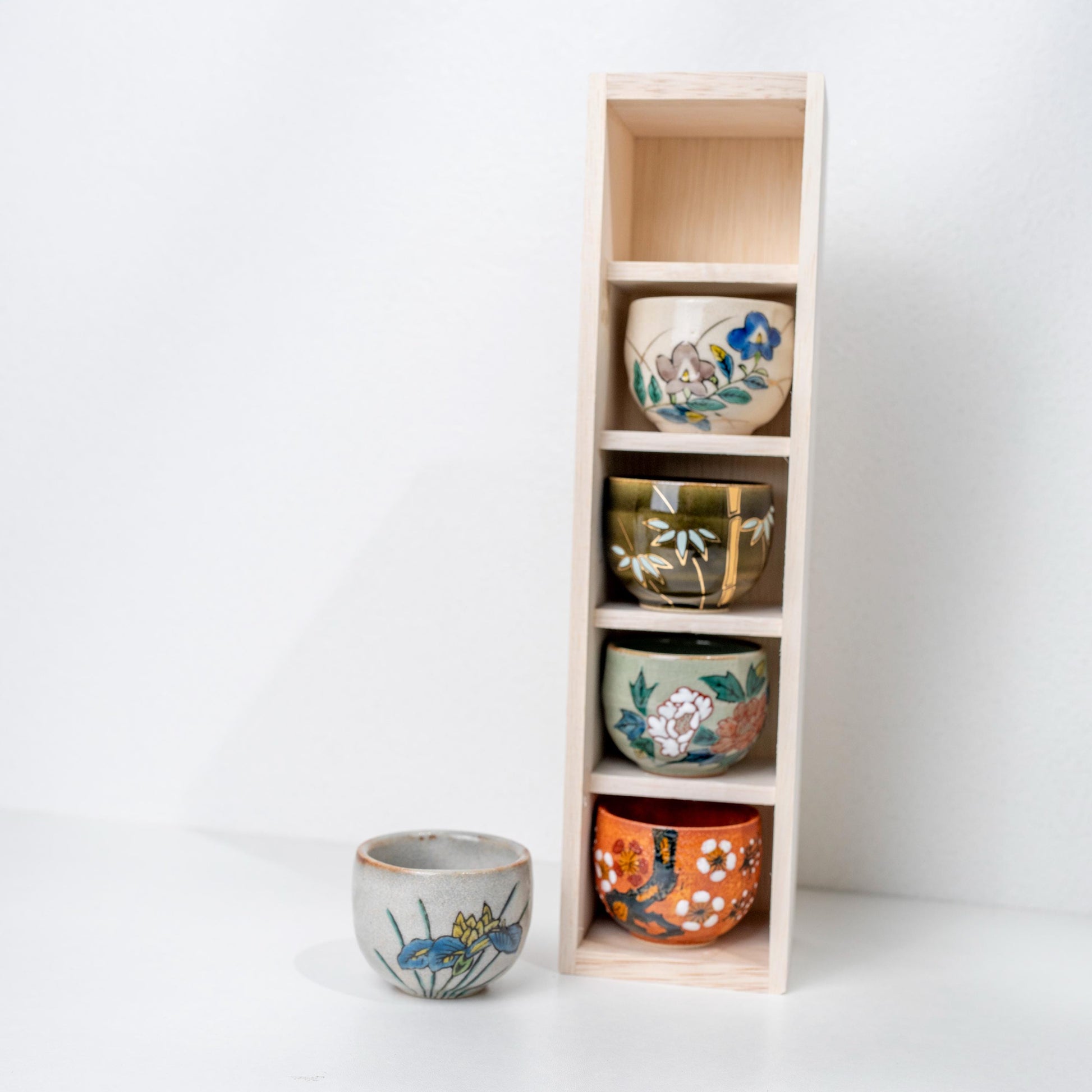 Front view of five Japanese sake cups in Kutani ware