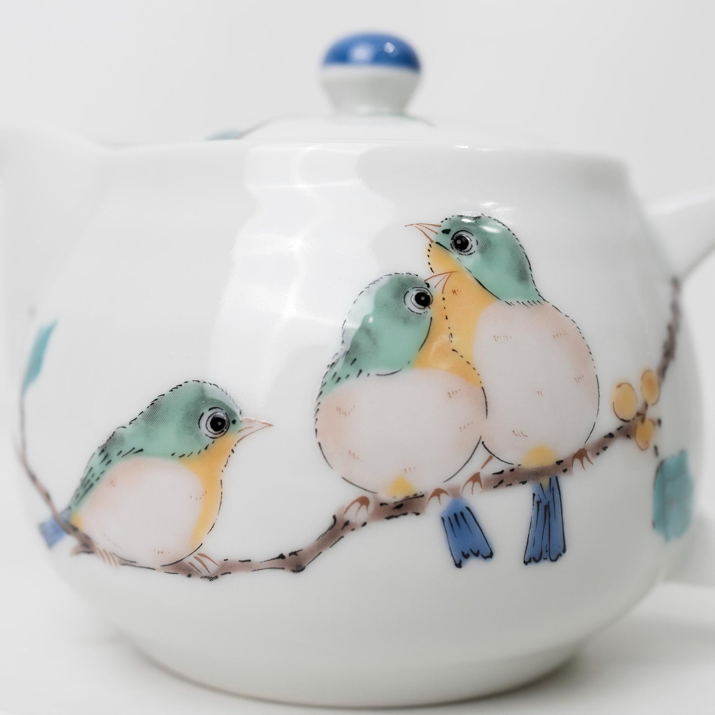 Side view of Japanese porcelain kyusu with painted bird motif