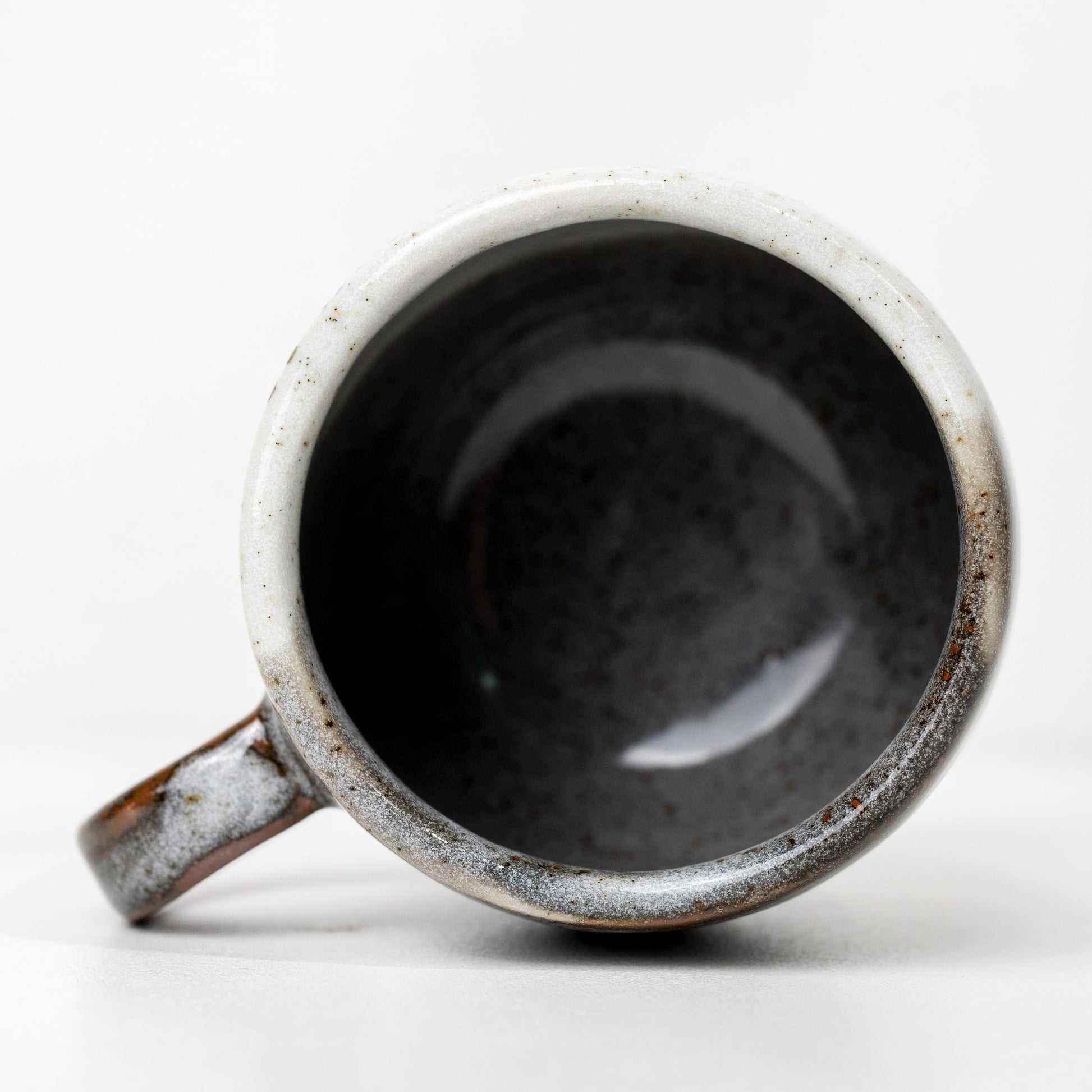 Front view of rustic ceramic mug with cat design