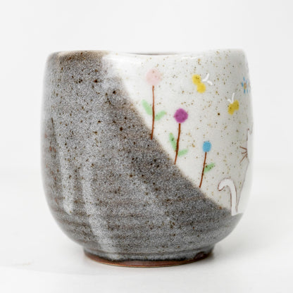 Back side of hand-painted Japanese cat mug with floral detail