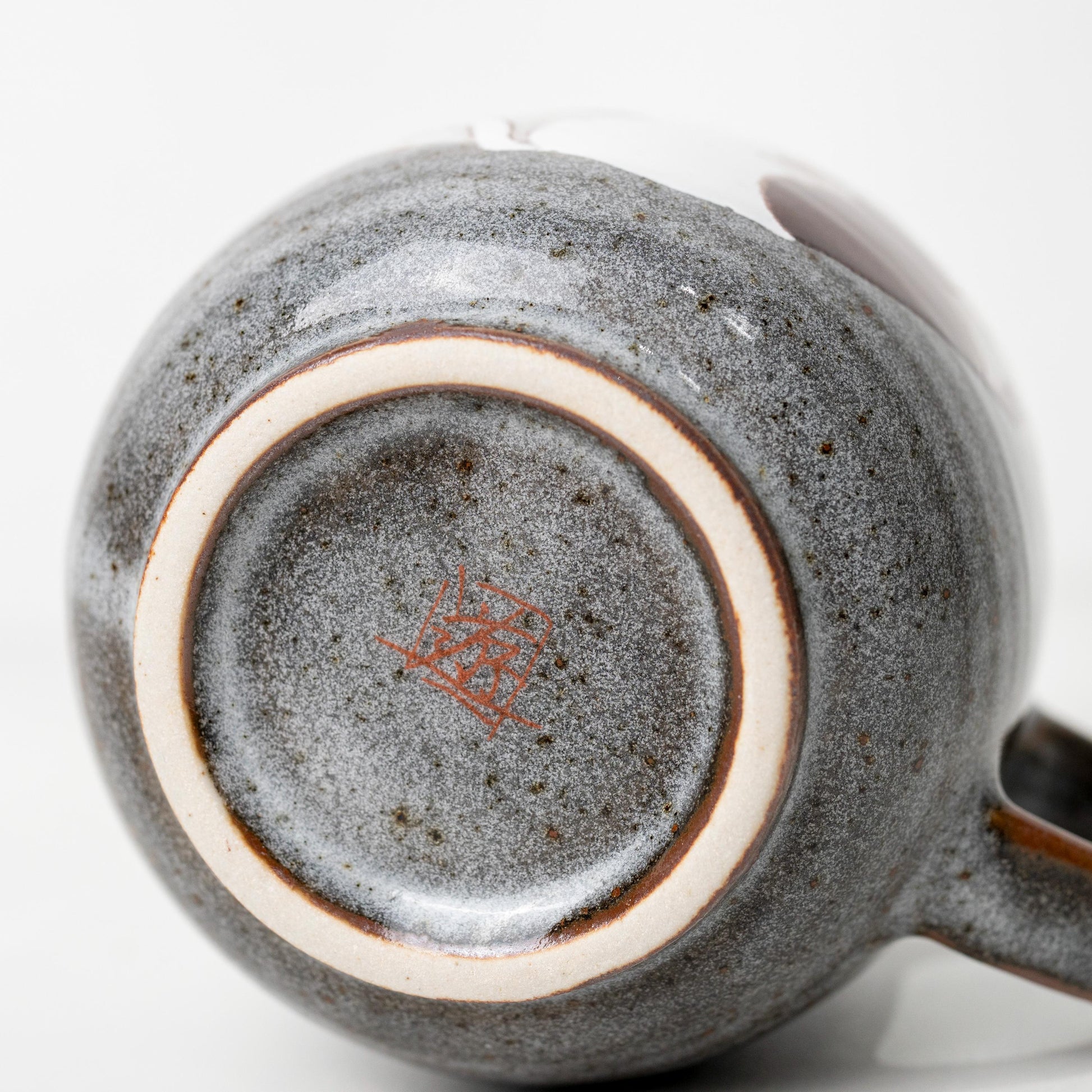 Underside of Kutani cat mug showing base mark and foot ring