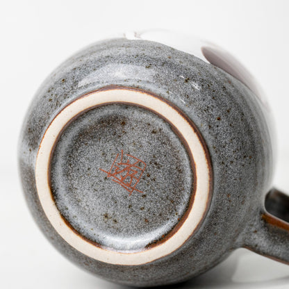 Underside of Kutani cat mug showing base mark and foot ring