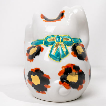 Close-up of side decoration on gold calico cat