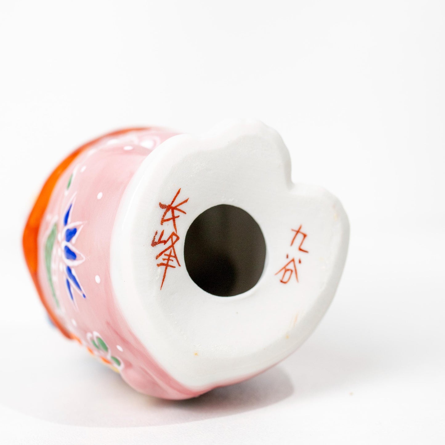 Underside of Kutani porcelain lucky cat showing base opening