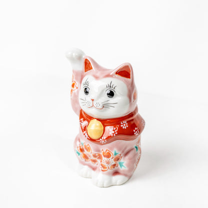 Side view of pink sakura lucky cat figurine
