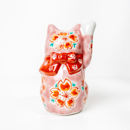 Back view of Kutani lucky cat with floral detail