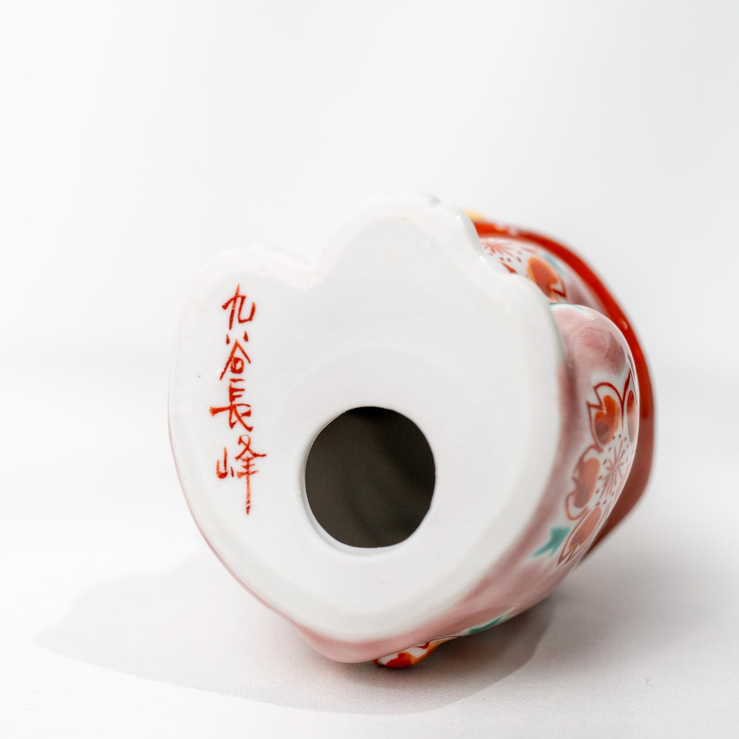 Underside of Kutani ceramic lucky cat showing base opening